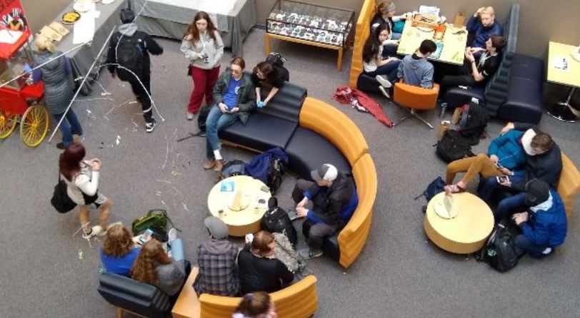 Students studying and socializing in the school lobby