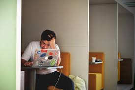 Stressed student looking at his computer